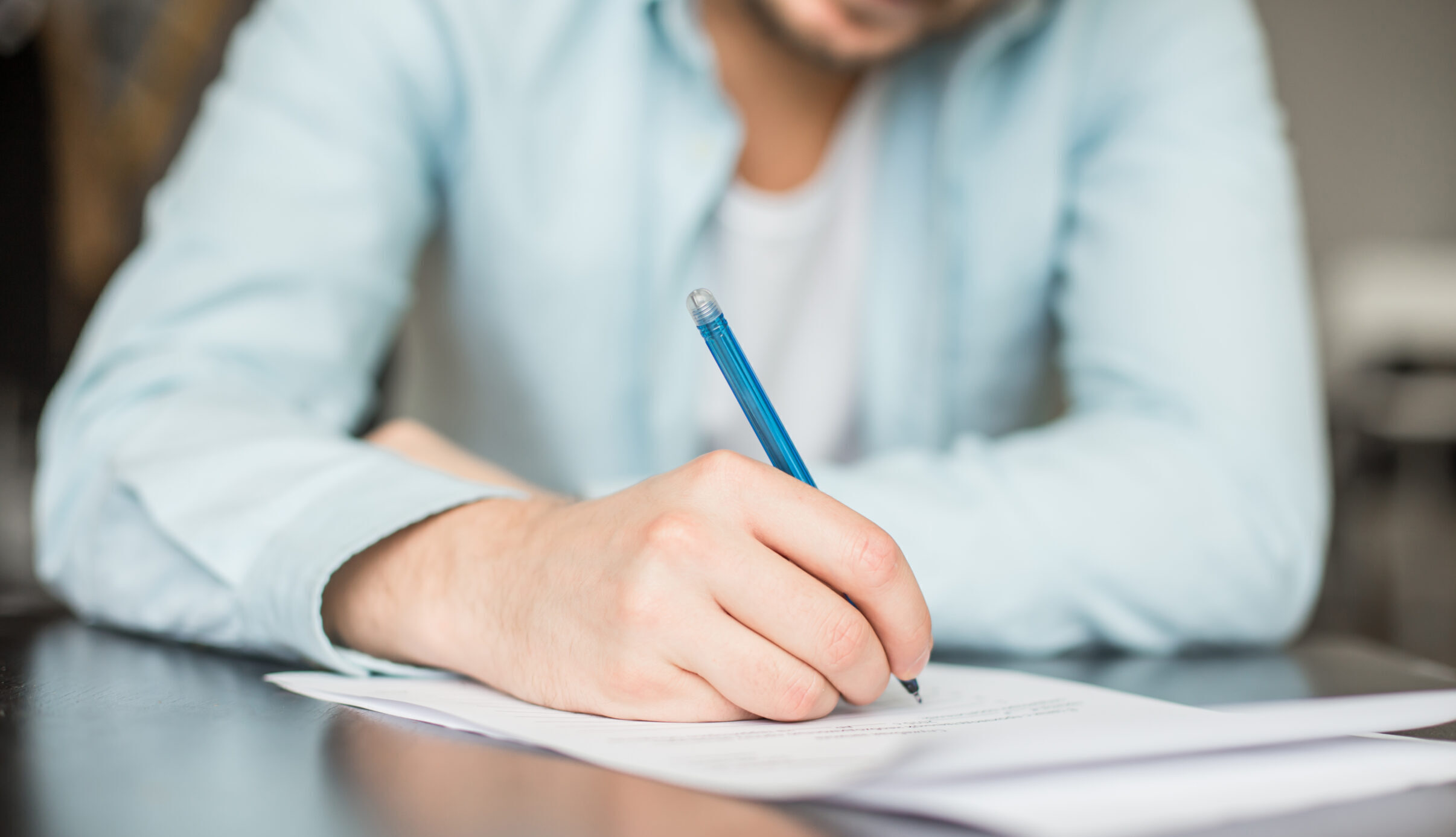 Man,Writing,At,The,Desk